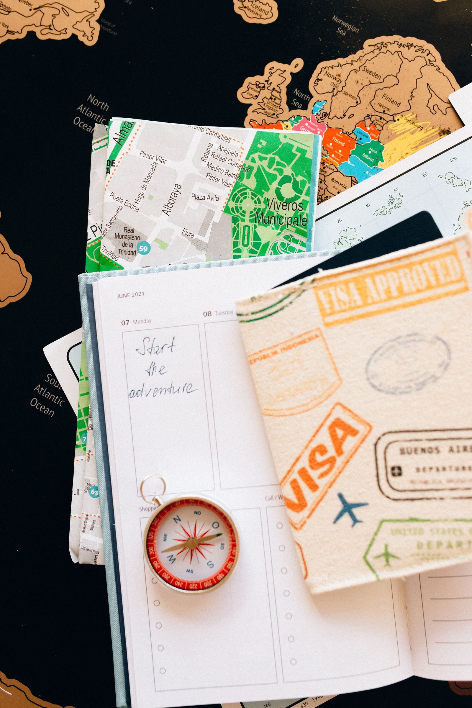 Travel planning notebook, map, and accessories laid out for an Ayurvedic trip to Kerala