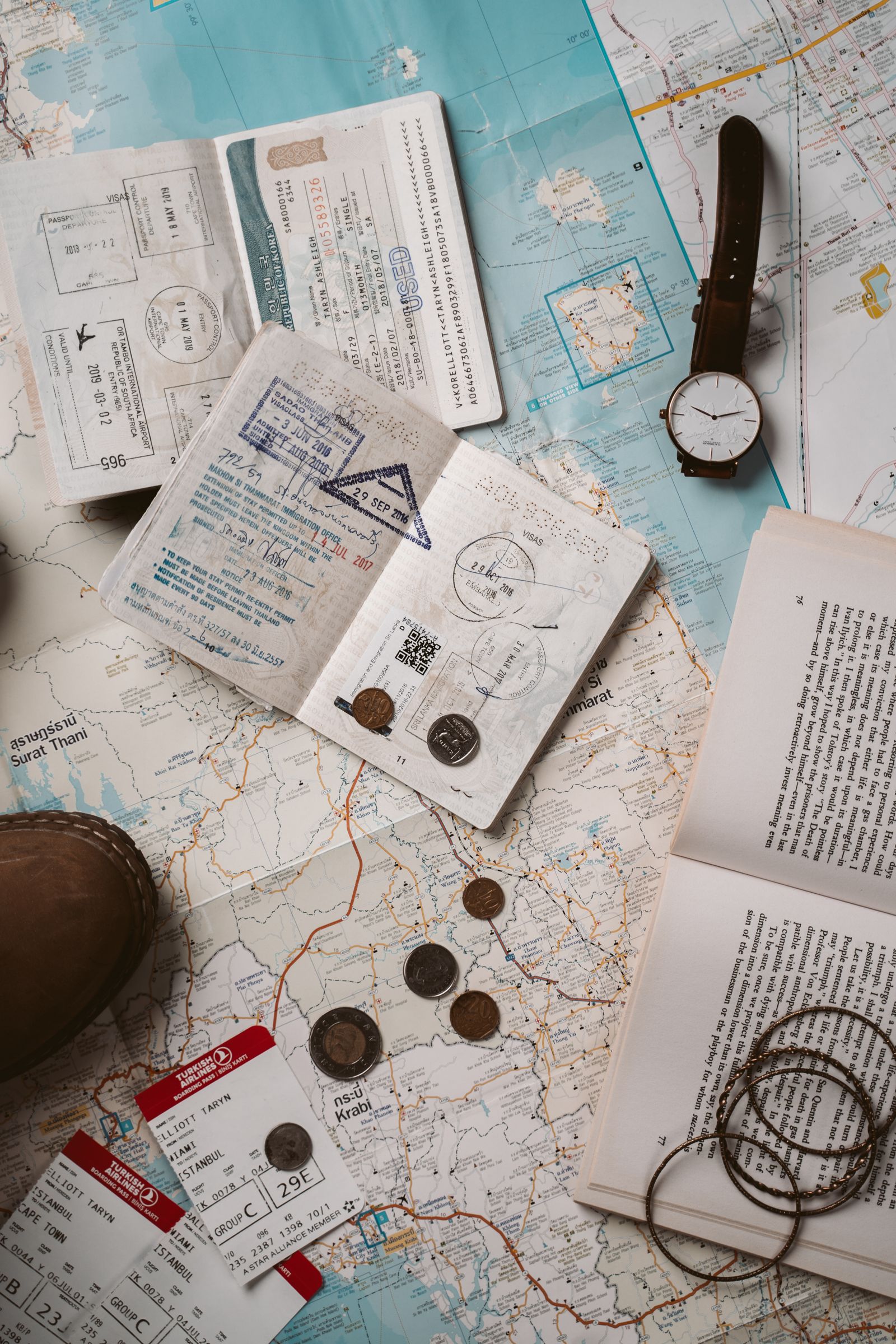Passport, world map, and travel essentials laid out for visa planning