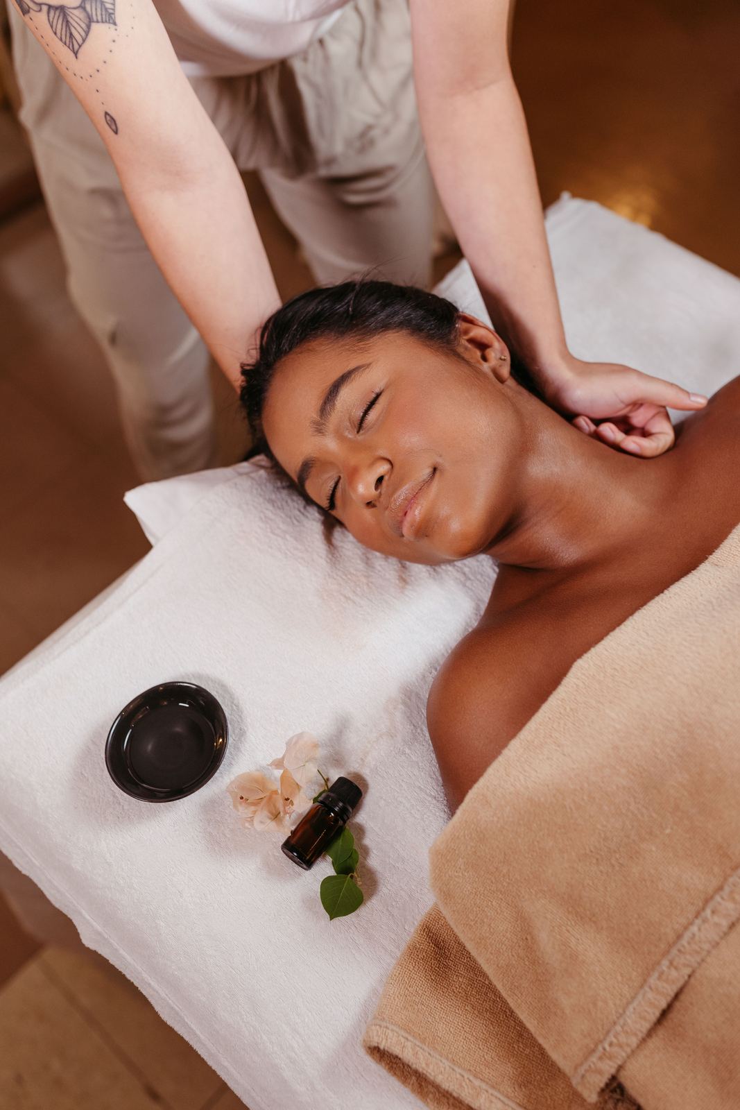 Shirodhara warm oil treatment being administered, a continuous stream of oil poured over the forehead