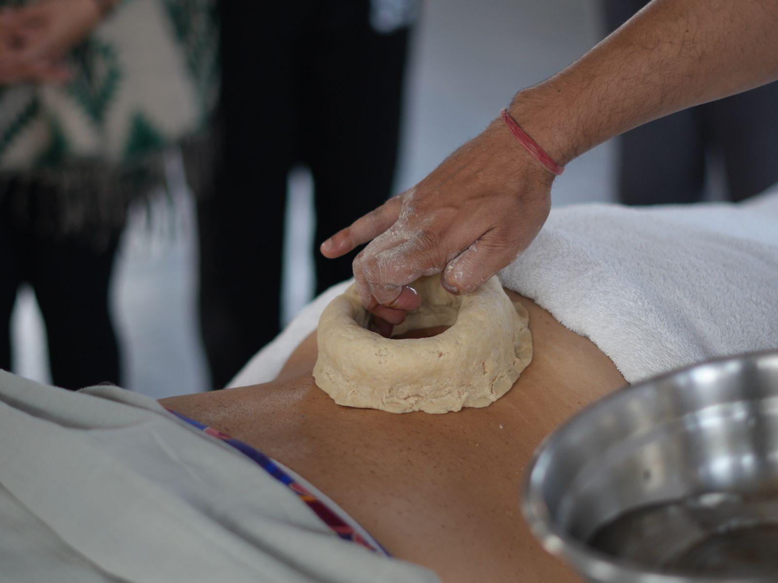 Traditional Ayurvedic Kati Basti oil therapy being administered for joint and back pain